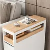 A narrow side table with wooden accents is placed next to a sofa, holding a magazine and a cup of coffee. Produktbild-Vorschau