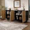 A modern sideboard with open doors, displaying its interior storage and decorative items, set in a well-lit room with a rug and artwork. Produktbild-Vorschau