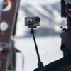 A person is holding an action camera on an extension rod in a snowy environment. Náhľad obrázku produktu