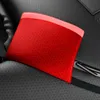 A close-up of a red pouch with a honeycomb pattern, resting on a textured black surface. Voir les images du produit