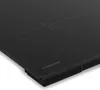 A close-up, angled view of a black induction cooktop. Náhľad obrázku produktu