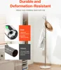 A coat rack with clothes and a hat on it, with comparison text about material quality. Náhled obrázku produktu