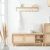 A bright and airy entryway with a wooden shoe bench, coat rack, and decorative elements. Produktbild-Vorschau