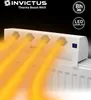 A white heater booster device is shown on top of a radiator, with orange heat waves emanating from it. Produktbild-Vorschau