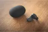 A pair of black Koss TWS250i earbuds and their charging case are placed on a wooden surface. Anteprima dell’immagine prodotto