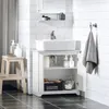 A white bathroom vanity with a sink and various bathroom accessories. Produktbild-Vorschau