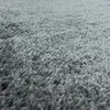 A close-up view of a gray shaggy carpet. Produktbild-Vorschau