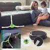 A woman is holding a baby on the floor next to a sofa, with a robot vacuum cleaner and its accessories visible. Voir les images du produit