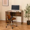 A desk with a computer and chair in a room. Produktbild-Vorschau