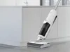A white and gray Hoover vacuum cleaner and floor washer is shown in a kitchen setting. Produktbild-Vorschau
