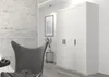 A modern interior hallway with a white wardrobe, a grey armchair, and a framed picture on the wall. Produktbild-Vorschau