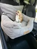 A small dog sits in a car seat designed for pets. Náhled obrázku produktu