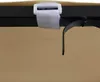 A close-up view of a tan awning attached to a black metal frame with a white velcro strap and a black strap. Produktbild-Vorschau