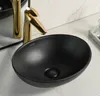 A black ceramic vessel sink with a gold faucet. Náhľad obrázku produktu