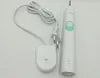 A white electric toothbrush and its charging base are shown on a white background. Produktbild-Vorschau