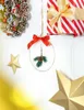 Christmas decorations including a wreath, gift box, and ornaments hanging on a white wall. Náhled obrázku produktu