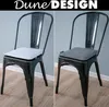 Two identical black metal chairs with different colored seat cushions are shown side-by-side. Produktbild-Vorschau