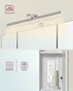 A collage showing the top and bottom parts of a bathroom cabinet. The top shows a LED light above mirrors, and the bottom shows electrical outlets and a toothbrush charging inside the cabinet. Náhled obrázku produktu