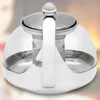 A close-up, top-down view of a glass teapot with a stainless steel handle and lid. Produktbild-Vorschau