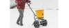 A person is using a spreader in the snow. Produktbild-Vorschau