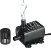 A black DC brushless water pump with water spraying from the outlet, shown with a separate filter attachment. Podgląd zdjęcia produktu