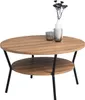 A round coffee table with two tiers and black metal legs, decorated with two glass cups and a vase with dried flowers. Produktbild-Vorschau