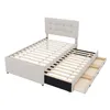 A beige upholstered bed frame with a headboard and a pull-out trundle bed with drawers, shown against a white background. Náhled obrázku produktu