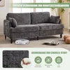 A modern gray chenille sofa is shown in a living room setting, with a robot vacuum cleaner underneath and decorative pillows nearby. Text overlays highlight product features. Produktbild-Vorschau