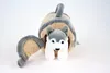 A plush husky toy peeking out of its den. Produktbild-Vorschau