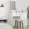 A white vanity table with drawers and a mirror, a stool, and a bedside table in a bedroom setting. Voir les images du produit