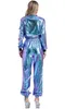 A woman is shown from behind wearing a metallic jumpsuit. Produktbild-Vorschau