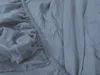 A close-up view of a dark blue jersey bedsheet, showing the elasticized edge and fabric texture. Produktbild-Vorschau