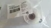 A white plastic roller with a metal bearing inside, packaged in clear plastic. A label with product information is attached. Produktbild-Vorschau