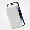 A white Wozinsky power bank is attached to the back of a black smartphone. Náhľad obrázku produktu