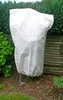 A plant protection bag covering a plant in a garden setting. Náhľad obrázku produktu