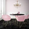 A dining set with pink velvet chairs and a black table, illuminated by a chandelier. Náhľad obrázku produktu