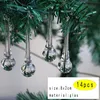 Clear glass icicle-shaped ornaments hanging from a green artificial Christmas tree branch. Produktbild-Vorschau