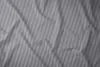 A close-up view of gray and white striped bedding. Produktbild-Vorschau