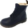 A black Dr. Martens boot with faux fur lining is shown against a white background. Podgląd zdjęcia produktu