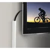 A white cable management channel is attached to a wall next to a television screen displaying a silhouette of a person riding a bicycle. Podgląd zdjęcia produktu