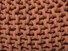A close-up view of a knitted pouf. Produktbild-Vorschau