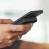 A person's hands are holding a smartphone with a magnetic power bank attached to the back. Voir les images du produit