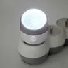 A close-up shot of a white and gray LED night light plugged into a power strip. Anteprima dell’immagine prodotto