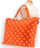 An orange polka dot tote bag displayed on a mannequin. Podgląd zdjęcia produktu