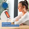A woman is using an infrared heat lamp for therapeutic purposes. Produktbild-Vorschau