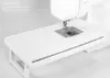 A white sewing machine with an extension table attached. Podgląd zdjęcia produktu