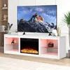 A white TV stand with a built-in electric fireplace and LED lighting, featuring a large television displaying a mountain landscape. Voir les images du produit