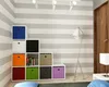 A modern room with striped walls, a storage unit with colorful bins, a floor lamp, and a door. Produktbild-Vorschau