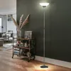 A modern living room with a floor lamp, a bar cart, and a sofa. Produktbild-Vorschau