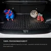 The interior of a car trunk with a rubber mat, roller skates, a soccer ball, and soccer cleats. Produktbild-Vorschau